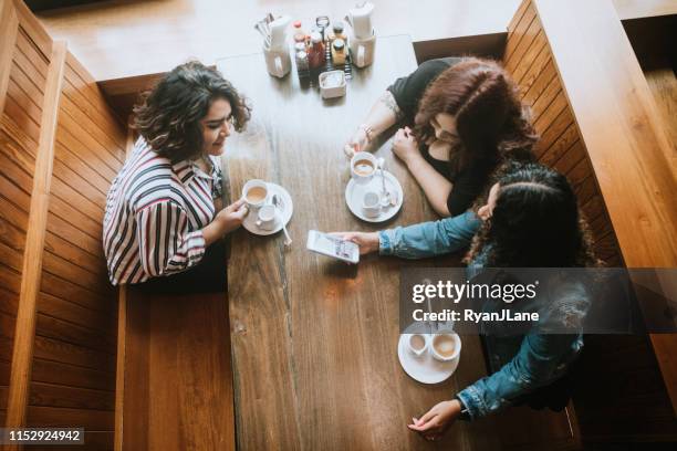 group of latina friends out for brunch - friends talking cafe stock pictures, royalty-free photos & images