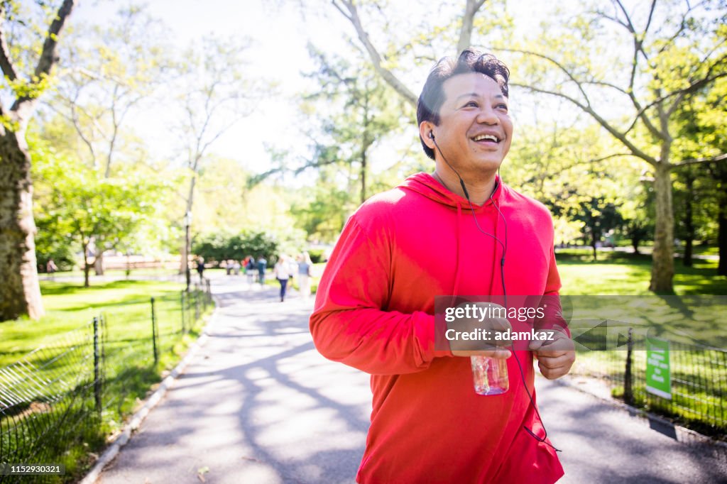 Mature Hispanic Man Jogging in Central Park