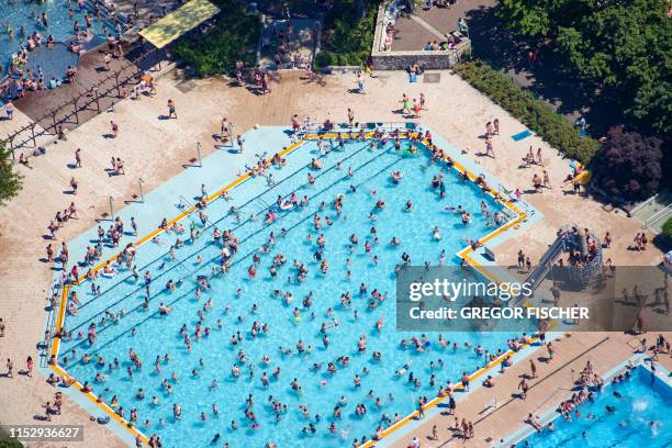 An aerial picture taken on June 30, 2019 shows people at an outdoor swimming pool in Berlin's Mariendorf district. / Germany OUT