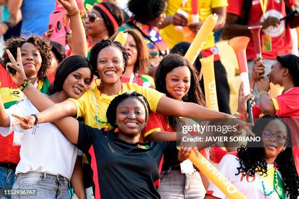 Guinea supporters pose during the 2019 Africa Cup of Nations Group B football match between Burundi and Guinea at the Al Salam Stadium in the...