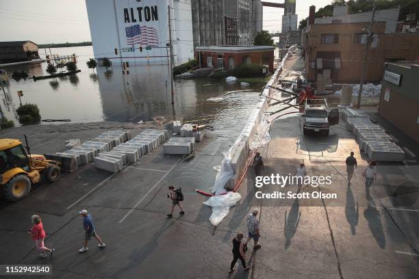 Temporary floodwall along Highway 100 holds back floodwater from the Mississippi River in the historic downtown area on May 31, 2019 in Alton,...