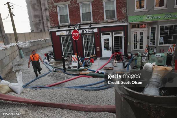 Pumps are used to try to stay ahead of creeping floodwater from the Mississippi River as it seeps into the historic downtown area on May 31, 2019 in...