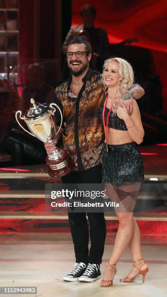 Former soccer player Dani Osvaldo and his dance partner Veera Kinnunen show their third place trophy at the Ballando Con Le Stelle tv show on May 31,...