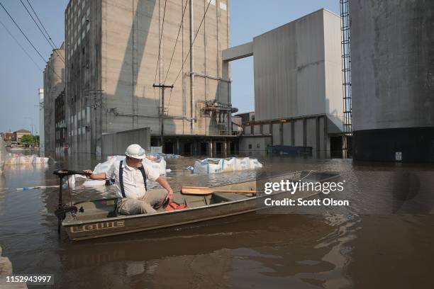 Worker ferries supplies through floodwater from the Mississippi River across Highway 100 to Ardent Mills on May 31, 2019 in Alton, Illinois. The...