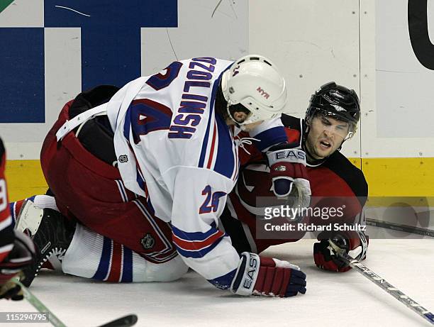 Sandis Ozolinsh of the New York Rangers knocks Brian Gionta of the New Jersey Devils to the ice during the third period of game two in the first...
