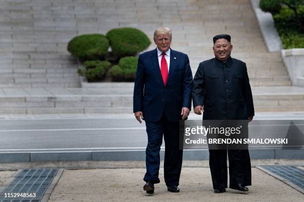 President Donald Trump and North Korea's leader Kim Jong-un walk on North Korean soil toward South Korea in the Demilitarized Zone on June 30 in...