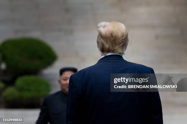 President Donald Trump waits at the line of demarcation for North Korea's leader Kim Jong-un in the Demilitarized Zone on June 30, 2019.