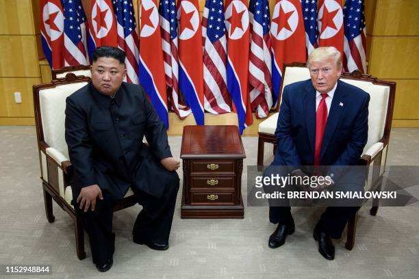 North Korea's leader Kim Jong Un and US President Donald Trump meet on the south side of the Military Demarcation Line that divides North and South...