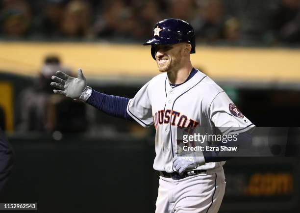 Derek Fisher of the Houston Astros smiles after he hit a home run in the eighth inning against the Oakland Athletics at Oakland-Alameda County...