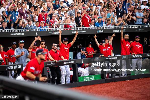 Players in the dugout react as Michael Chavis of the Boston Red Sox catches a foul ball during the sixth inning of game two of the 2019 Major League...