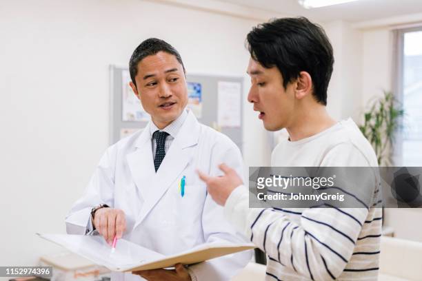 patient asking doctor questions about his medical results - manquestionmark stock pictures, royalty-free photos & images