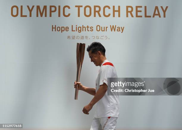 Tokyo 2020 Torch Relay Official Ambassador Tadahiro Nomura holds the Tokyo 2020 Olympic Games torch upon his arrival at the Tokyo 2020 Torch Relay...