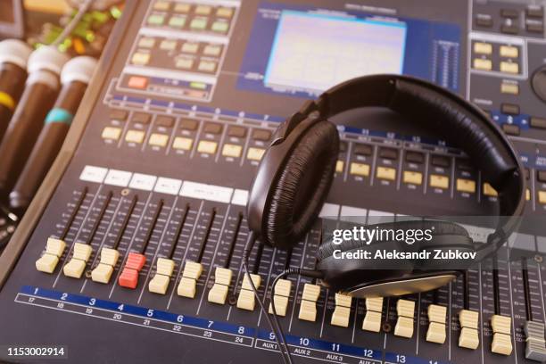 headphones, microphones, amplifying equipment, studio audio mixer knobs and faders, background sound mixer. workplace and equipment sound engineer. sound acoustic music mixing, selective focus - scoring music stock pictures, royalty-free photos & images