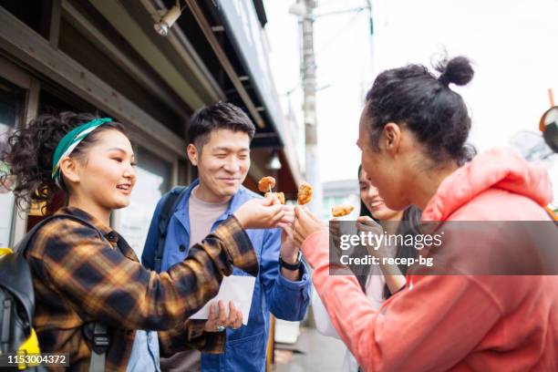 group of multi-ethnic friends sharing street food - philippines friends stock pictures, royalty-free photos & images