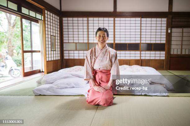 portrait of japanese inn owner sitting in room - kimono stock pictures, royalty-free photos & images