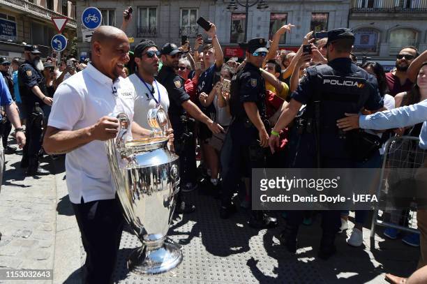 Former Real Madrid player Roberto Carlos leaves Puerta del Sol Square carrying the Champions League Trophy on the way to the stadium prior to the...
