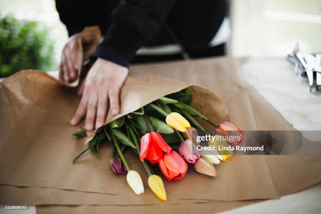 Bunch Of Rainbow Tulips In Brown Paper Wrap High-Res Stock Photo
