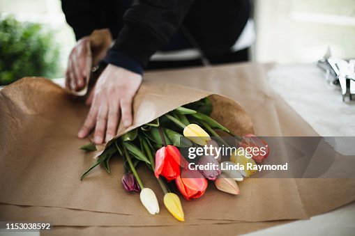 Bunch of rainbow tulips in brown paper wrap Bunch of rainbow tulips in brown paper wrap
