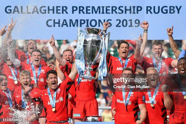 Brad Barritt and Owen Farrell of Saracens lift the trophy after winning the the Gallagher Premiership Rugby Final between Exeter Chiefs and Saracens...