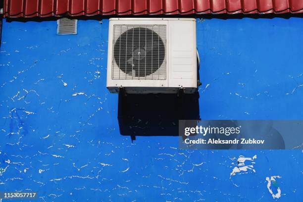 industrial ventilation, air conditioning installed on the old textured shabby wall with natural defects. blue abstract wall with scratches, cracks, chips, irregularities. copy space for text. - blue ventilation stock pictures, royalty-free photos & images