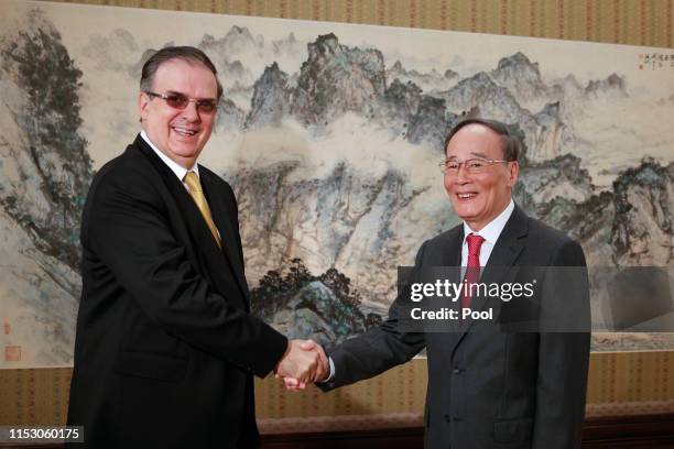 Mexican foreign minister Marcelo Ebrard, left, shakes hands with Chinese Vice President Wang Qishan before a meeting at the Zhongnanhai leadership...