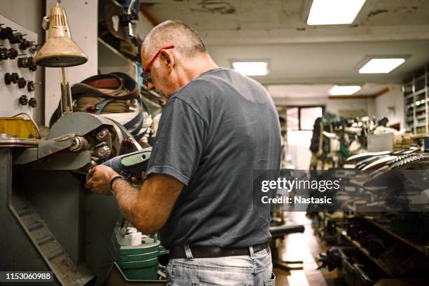 shoemaker polishing shoe - shoe factory stock pictures, royalty-free photos & images