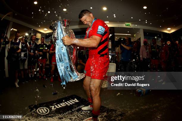 Richard Wigglesworth of Saracens celebrates inside the dressing room with the trophy following the Gallagher Premiership Rugby Final between Exeter...