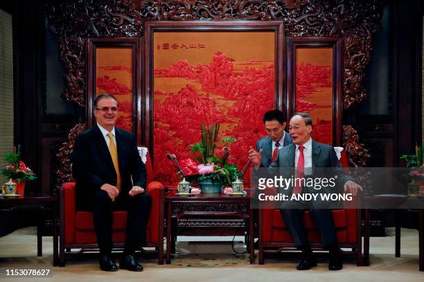 Chinese Vice President Wang Qishan speaks with Mexican Foreign Minister Marcelo Ebrard during a meeting at the Zhongnanhai leadership compound in...
