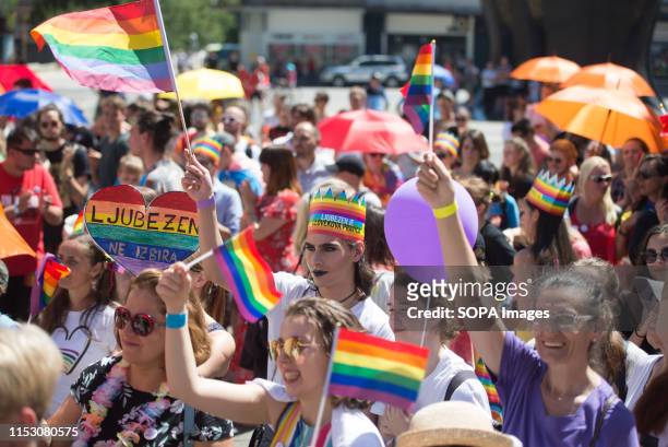 People holds placards and rainbow flags during the Pride parade. About 800 people came out at the first Pride parade held in Maribor on Saturday....