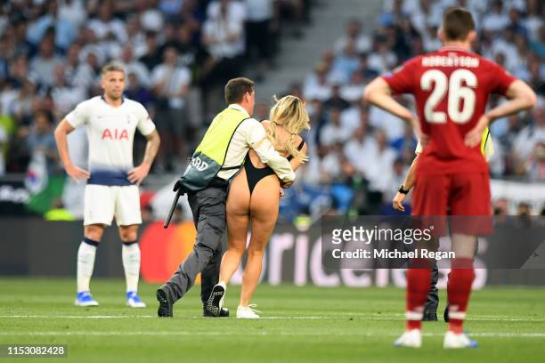 Pitch invader Kinsey Wolanski is caught after running onto the field during the UEFA Champions League Final between Tottenham Hotspur and Liverpool...