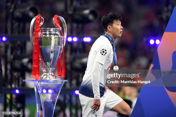 Heung-Min Son of Tottenham Hotspur walks past the Champions League Trophy following the UEFA Champions League Final between Tottenham Hotspur and...