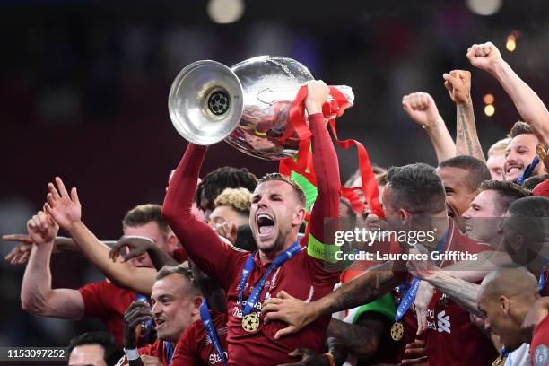 Jordan Henderson of Liverpool lifts the Champions League Trophy after winning the UEFA Champions League Final between Tottenham Hotspur and Liverpool...