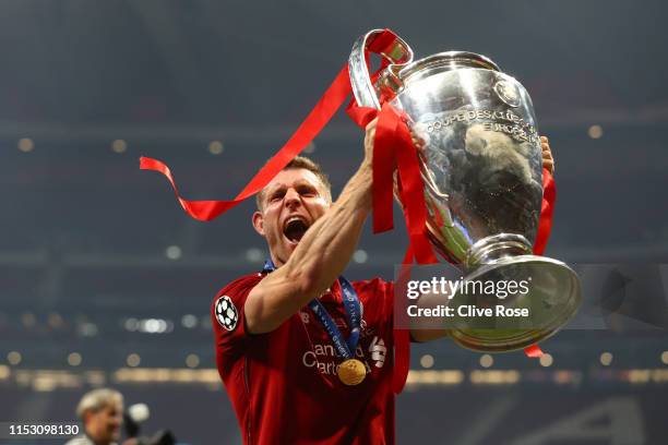 James Milner of Liverpool celebrates with the Champions League Trophy after winning the UEFA Champions League Final between Tottenham Hotspur and...