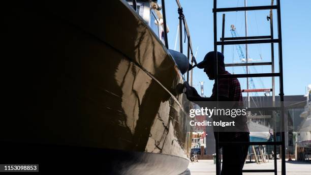 luxury yacht maintenance at the marina - repairing boat stock pictures, royalty-free photos & images