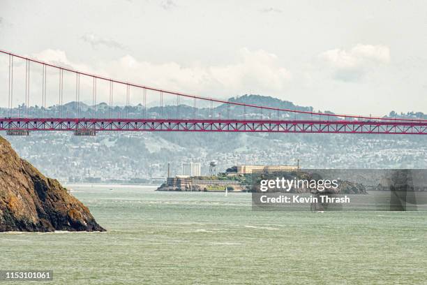 alcatraz under the golden gate bridge - alcatraz stock pictures, royalty-free photos & images