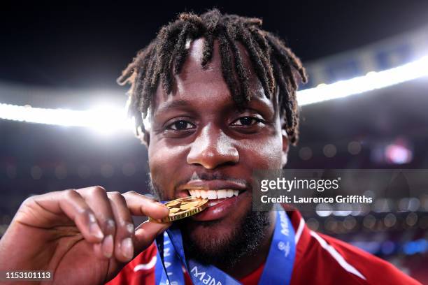 Divock Origi of Liverpool celebrates with his medal after winning the UEFA Champions League Final between Tottenham Hotspur and Liverpool at Estadio...