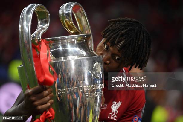 Divock Origi of Liverpool celebrates with the Champions League Trophy after winning the UEFA Champions League Final between Tottenham Hotspur and...