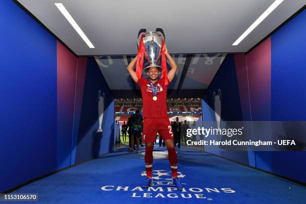 Alex Oxlade-Chamberlain of Liverpool poses with the Champions League Trophy after winning the UEFA Champions League Final between Tottenham Hotspur...