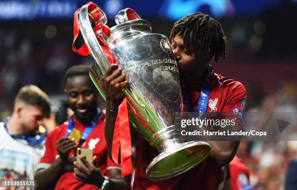 Divock Origi of Liverpool celebrates with the trophy during the UEFA Champions League Final between Tottenham Hotspur and Liverpool at Estadio Wanda...