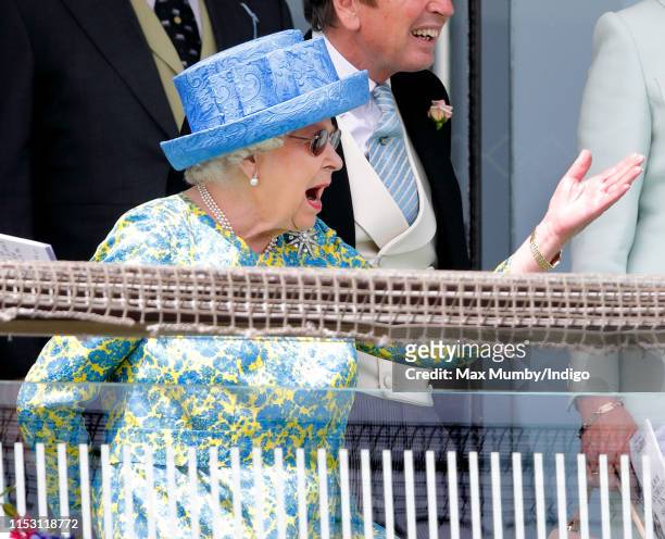 Queen Elizabeth II watches the racing as she attends 'Derby Day' of the Investec Derby Festival at Epsom Racecourse on June 1, 2019 in Epsom, England.
