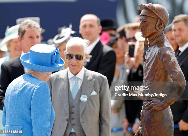 Queen Elizabeth II talks with former jockey Lester Piggott after unveiling as statue of him as she attends 'Derby Day' of the Investec Derby Festival...