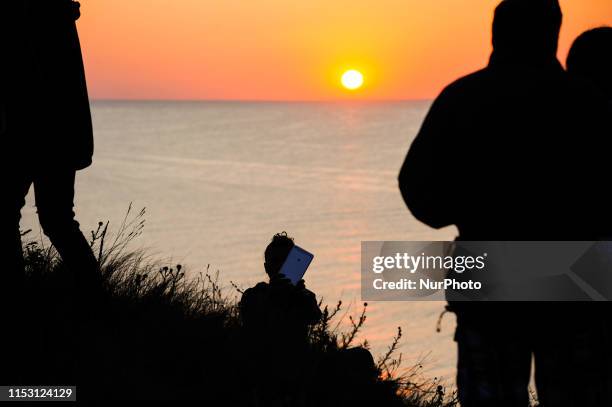 People gathered to watch the sun rising from the sea on July 1, 2019. People welcoming the first sunrise of July at the most Eastern part of...
