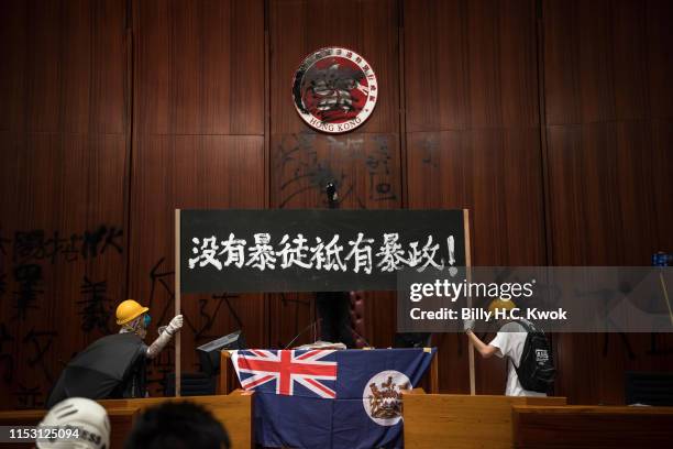Protesters deface the Hong Kong logo at the Legislative Council to protest against the extradition bill on July 1, 2019 in Hong Kong, China....