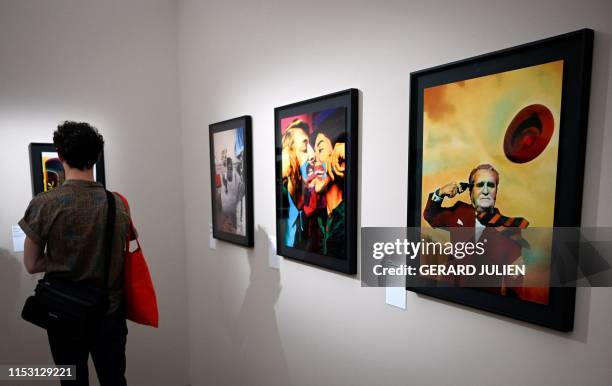 Man visits the exhibition "La Movida - A chronicle of turmoil, 1978-1988" by Spanish photographer Ouka Leele during the photography festival "Les...