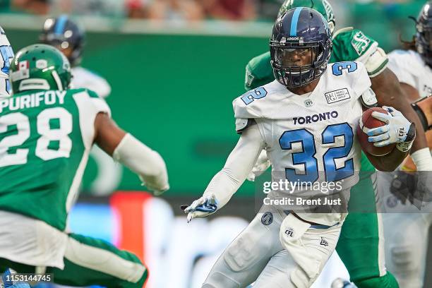 James Wilder Jr. #32 of the Toronto Argonauts looks to avoid Loucheiz Purifoy of the Saskatchewan Roughriders during a run in the game between the...