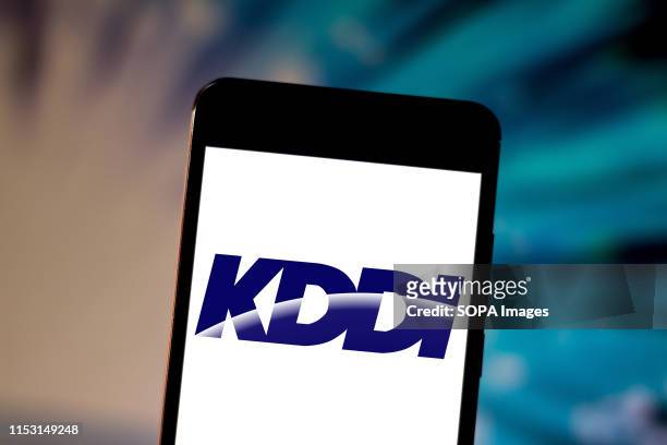 In this photo illustration the KDDI Corporation logo is seen displayed on a smartphone.