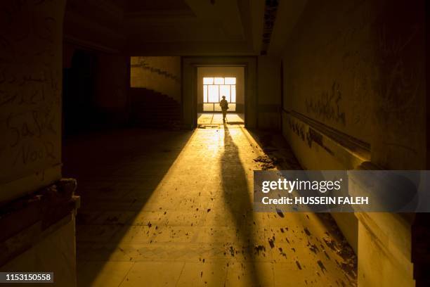 Picture taken on June 29, 2019 shows a partial view of a former palace of deposed Iraqi dictator Saddam Hussein at the ancient archaeological site of...