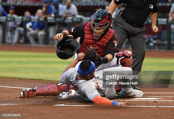 Dominic Smith of the New York Mets scores on a double by teammate Pete Alonso ahead of the tag by Alex Avila of the Arizona Diamondbacks during the...