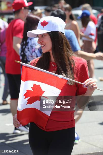 Woman holds a Canadian flag during Canada Day celebrations in Toronto, Ontario, Canada on July 01, 2019. The 152nd anniversary of Canada was...