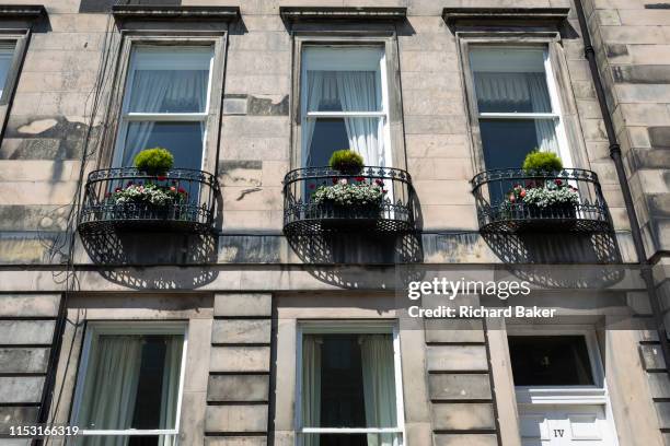 Housing architecture plus ironwork balconies and street lighting on Gloucester Terrace in Edinburgh, on 26th June 2019, in Edinburgh, Scotland.